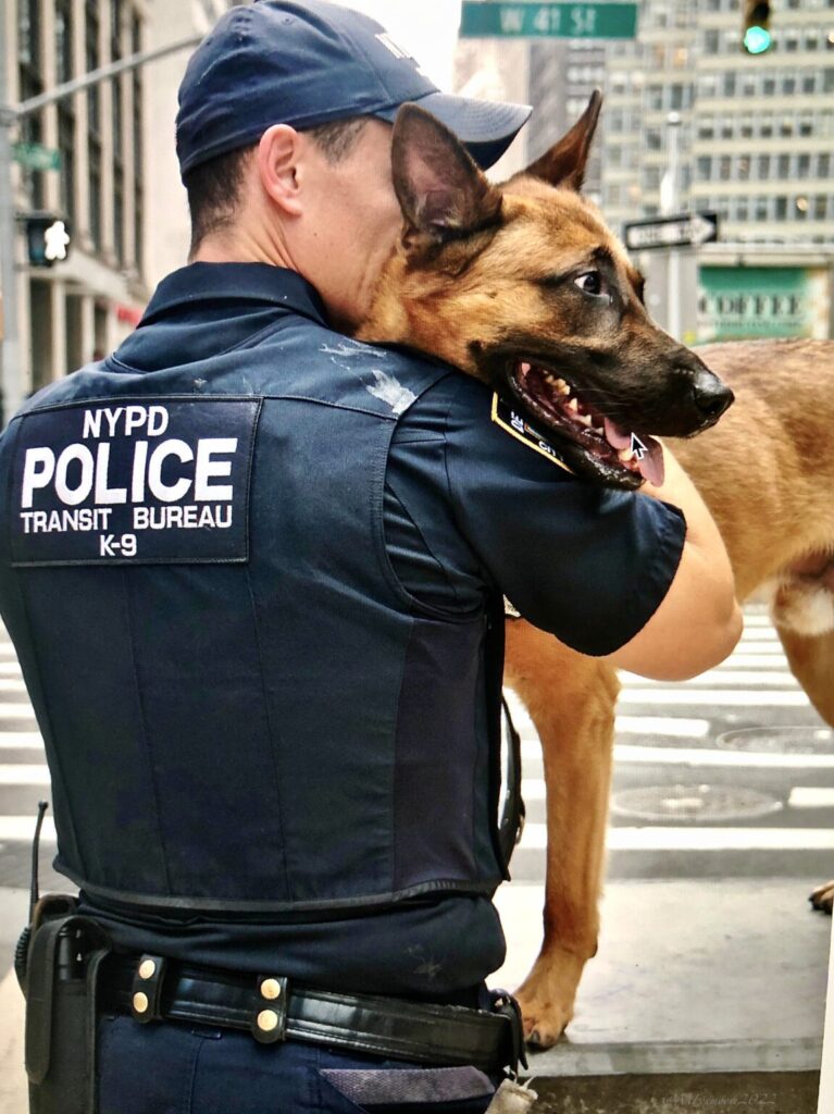 An officer and his K9 posing for "dogs outside the ring, the dogs that serve" Photography book 