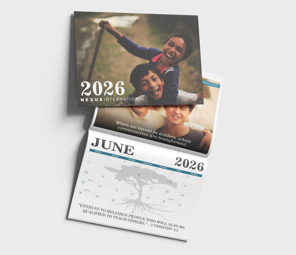 cover and june page of nexus international calendar two boys laughing on the cover holding each other