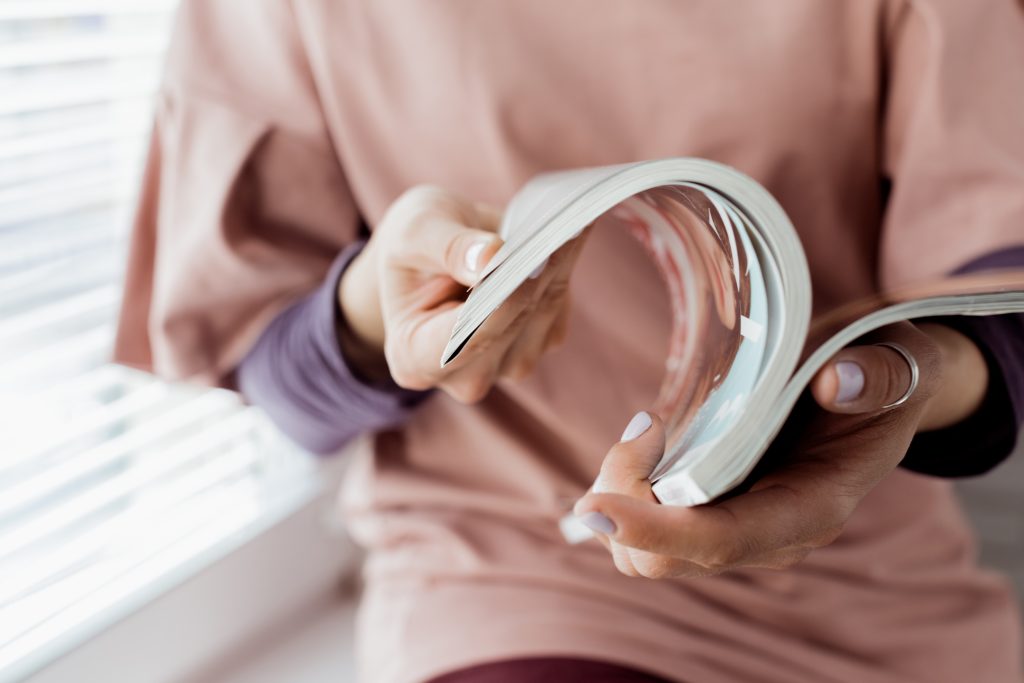 Young woman with a booklet with blank pages