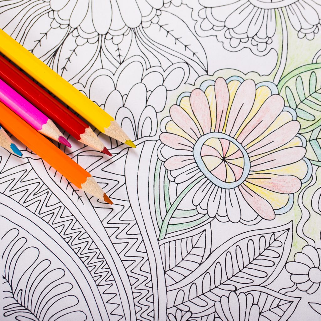 Multi-colored pencils and coloring book for adults