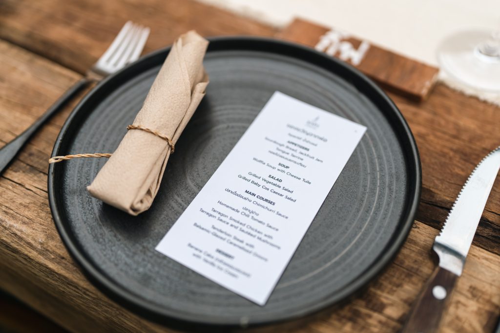 Plate menu napkin table cutlery elegant restaurant place setting on wooden table